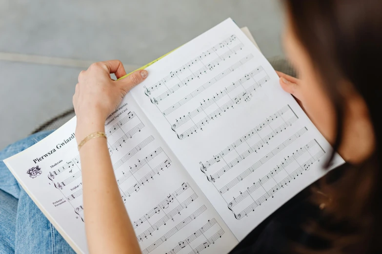 a woman reading a music score