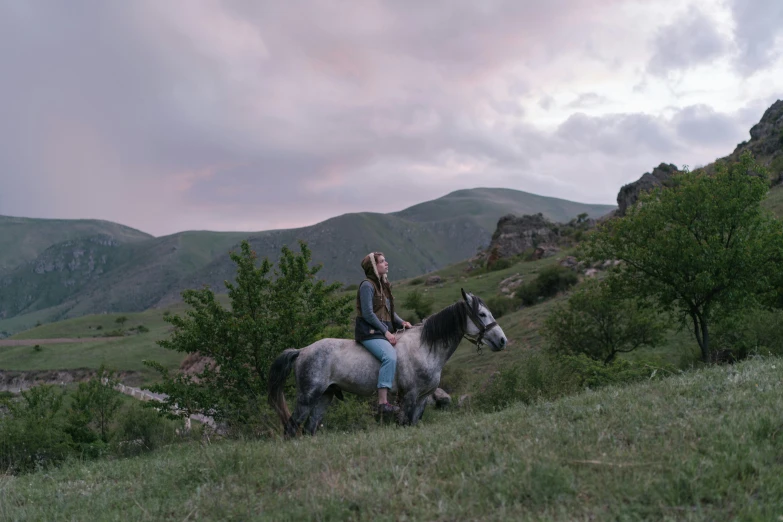 a  rides a horse in the mountains