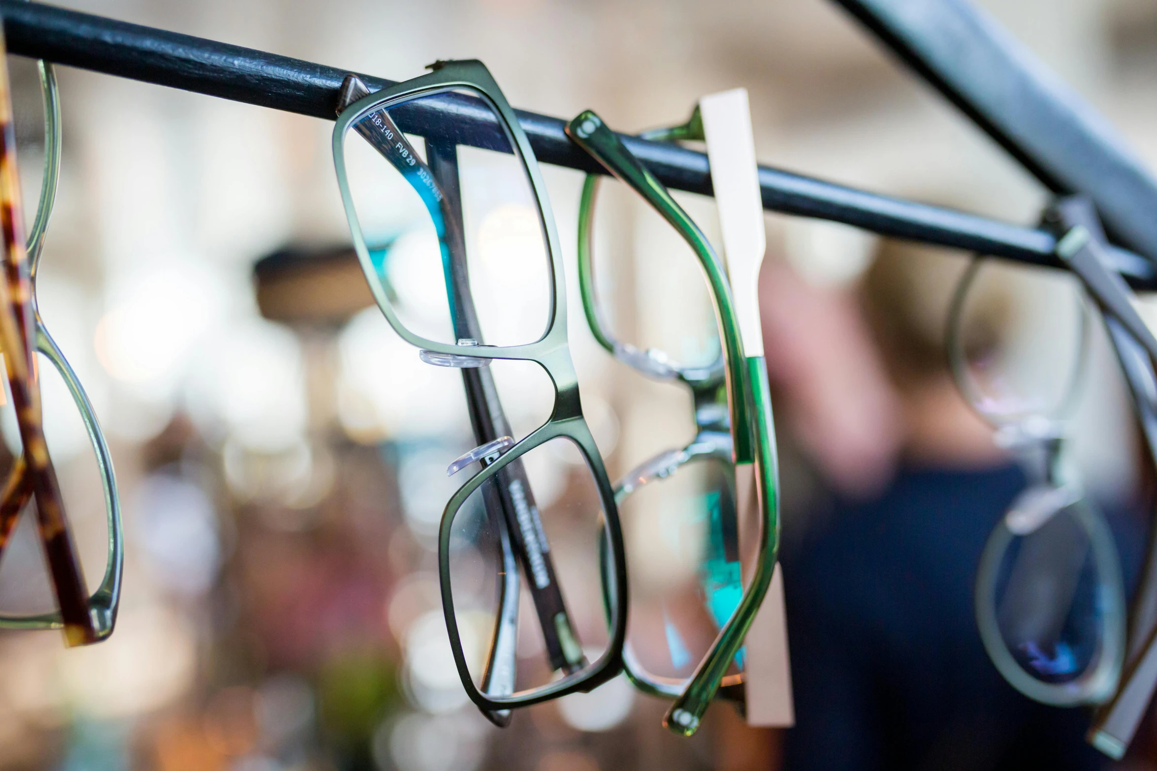 a couple of pairs of glasses hanging from a rail