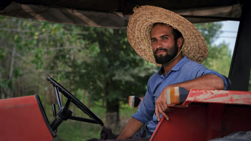 the man in the straw hat is on the farm