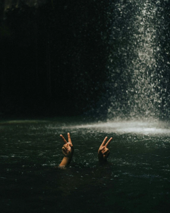 two people in the water making peace signs