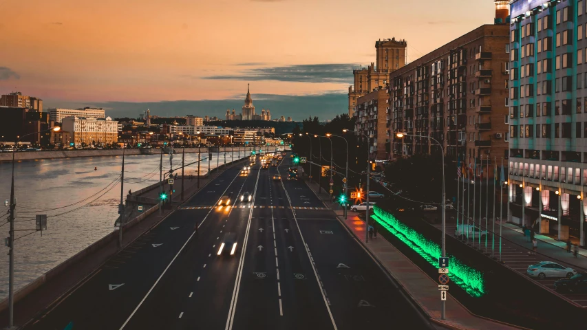 cars move along an empty road in a city