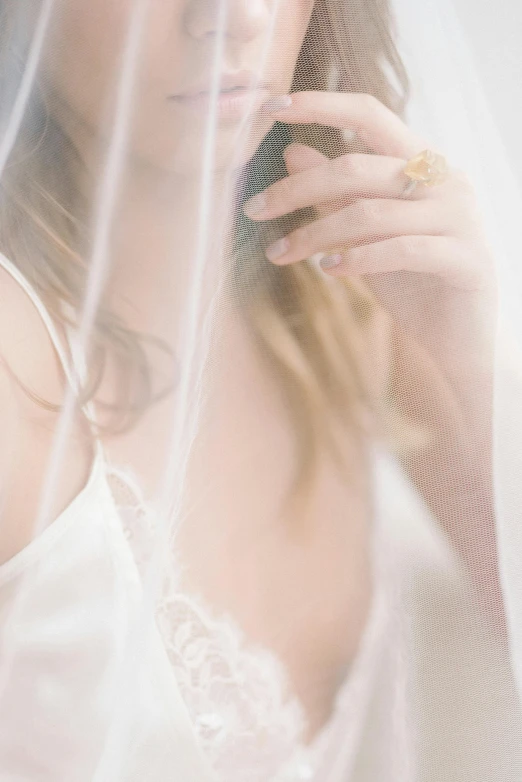 a woman with veil on the side talking on her cell phone