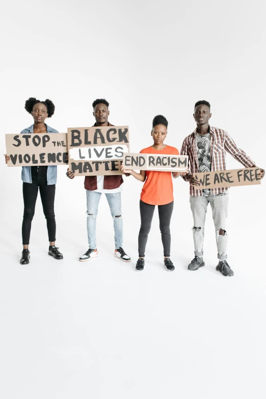 group of young people holding signs saying stop the black lives murdered racism free