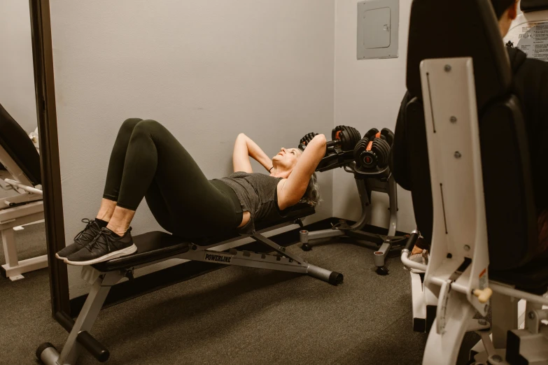 the woman in the gym is taking a break