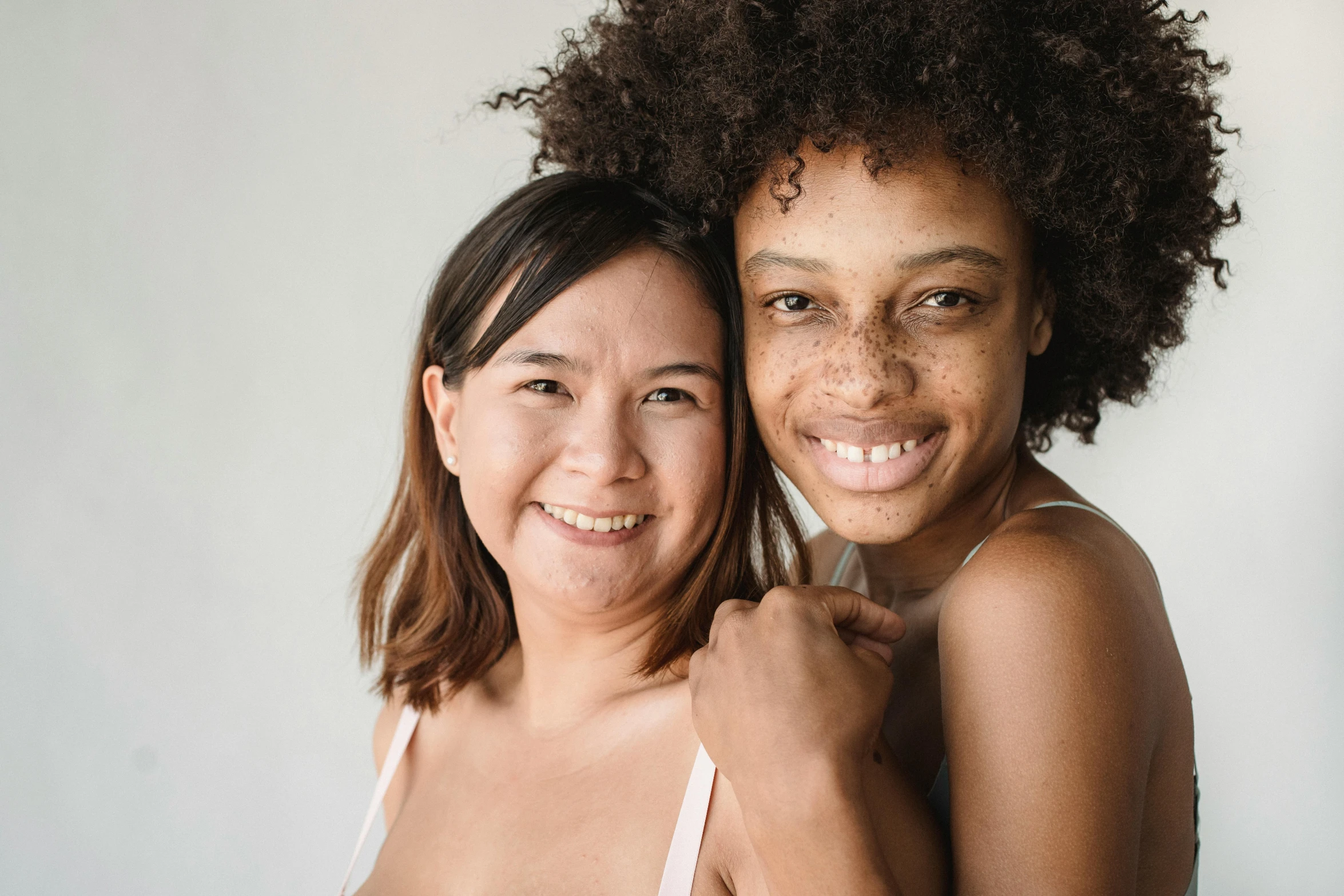 an older woman smiling next to a young woman