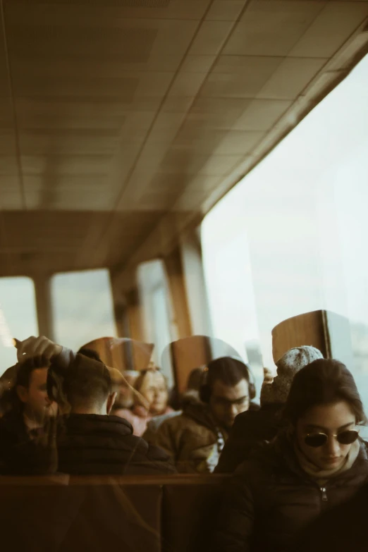 a man and woman on a bus next to some passengers