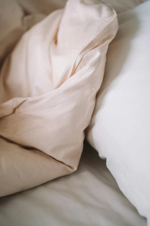 a picture of some sheets with a white pillow