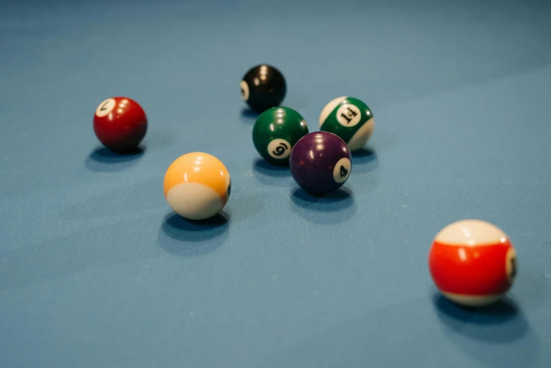 a number of different billiard balls in a pool table