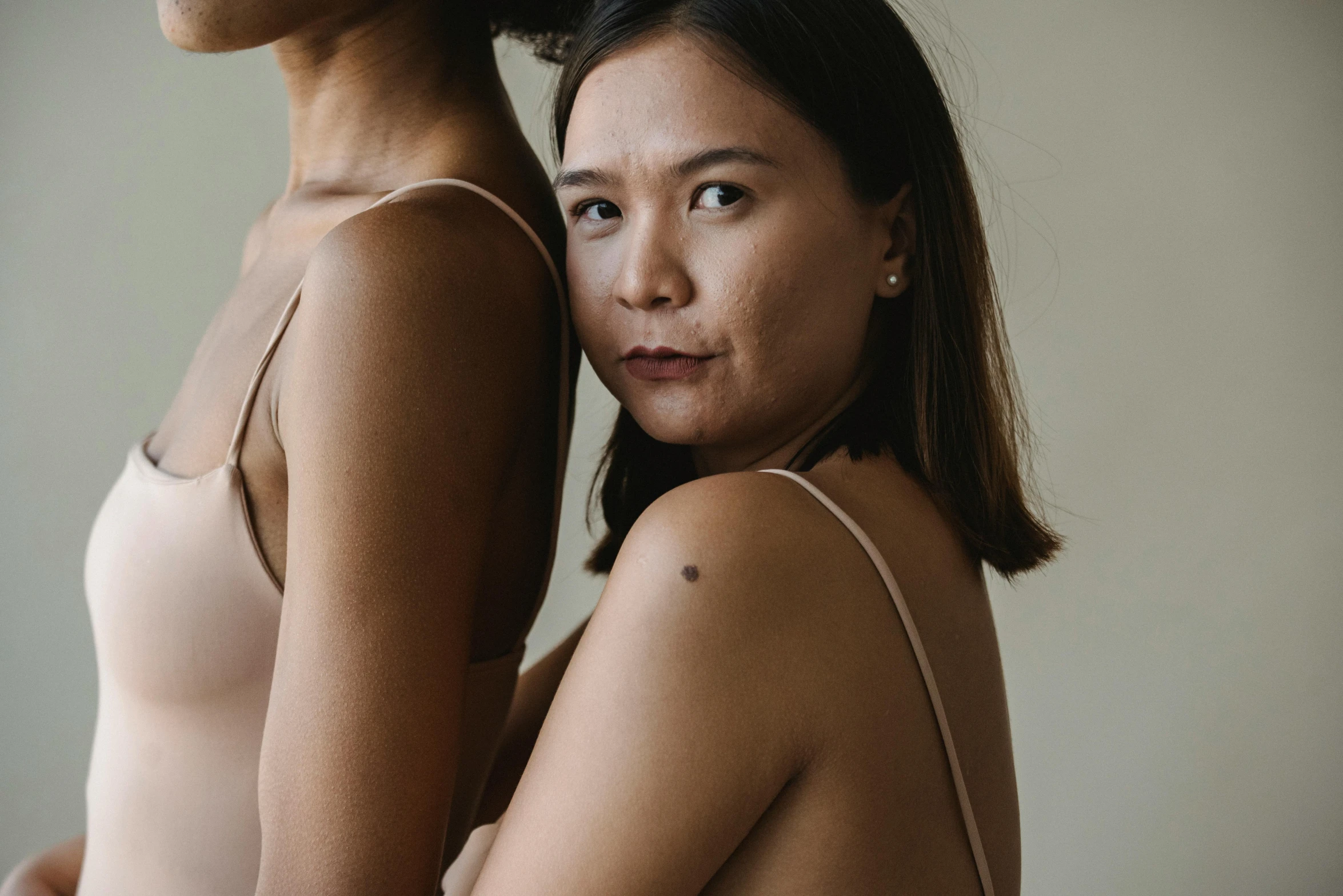 two women posing with one in front of her and the other behind her