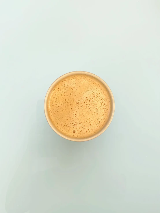 top view of a cup of coffee on a blue table