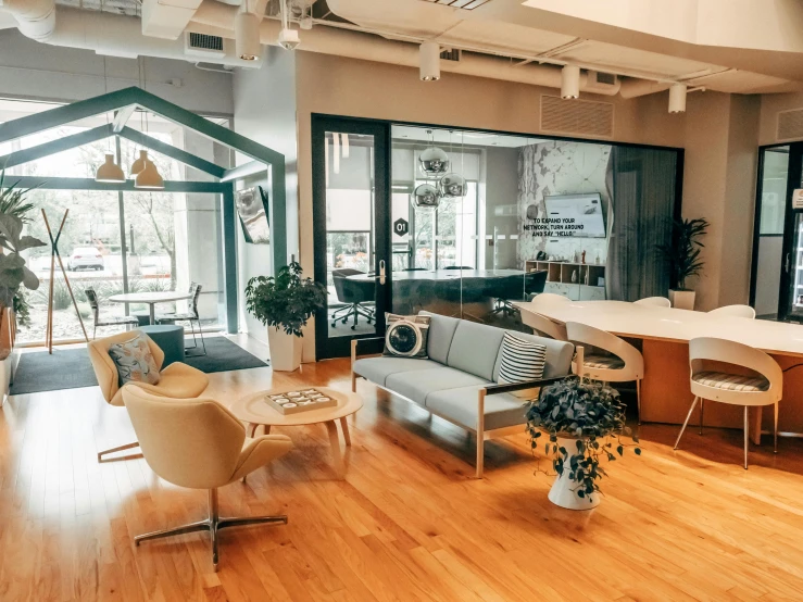 an open living room with hardwood floors, wood furniture, and an open kitchen