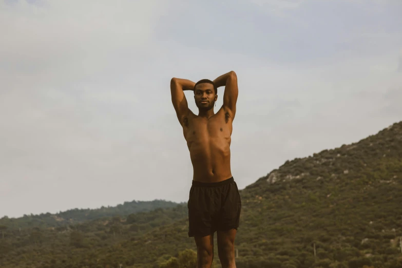 a man that is standing up and holding his head