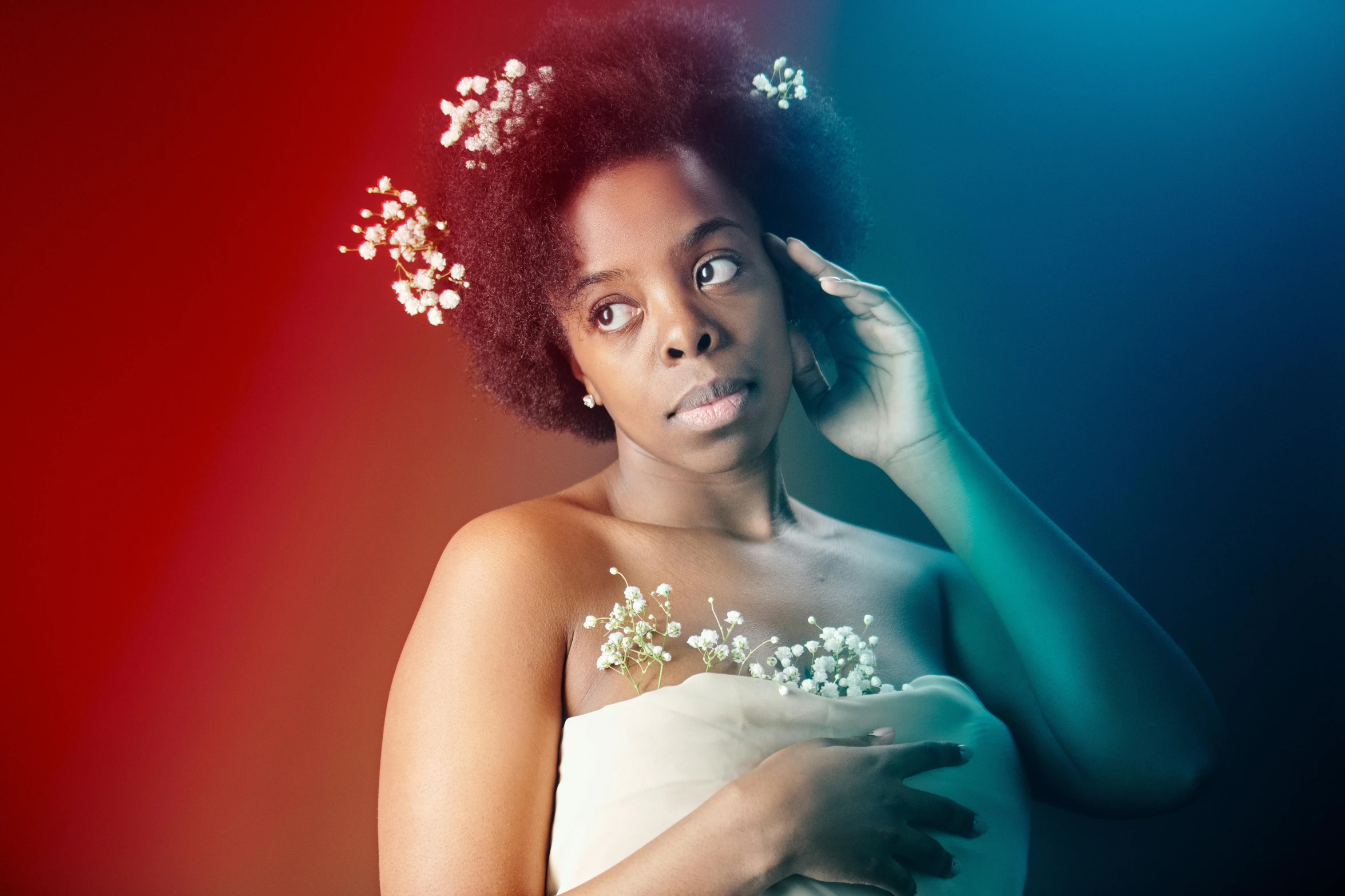 a young woman with flower headband on and her hand to the side