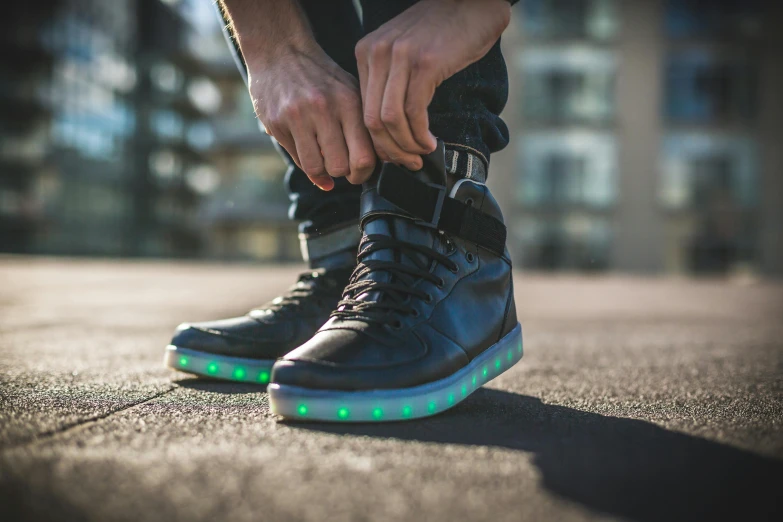 a person with their hand on their shoe with glowing light up shoes