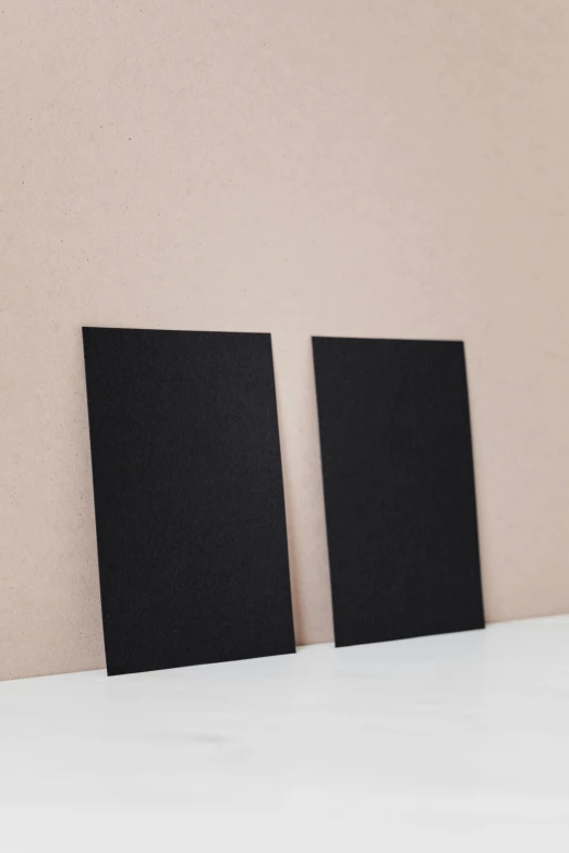 two empty black canvass sitting on top of a table