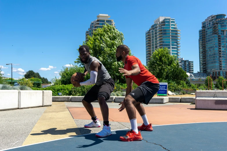 two men are playing basketball on a court