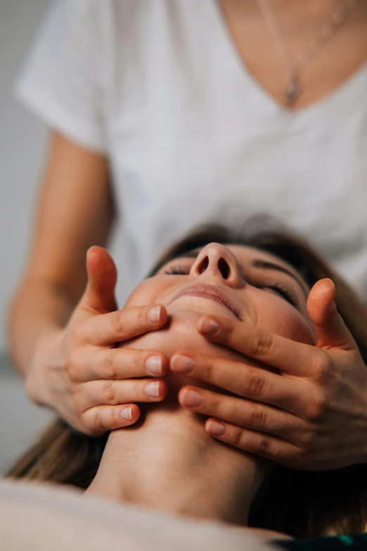 woman having head massage in spa room