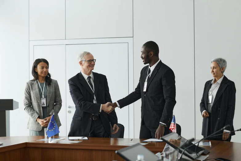 two men shaking hands in a meeting room