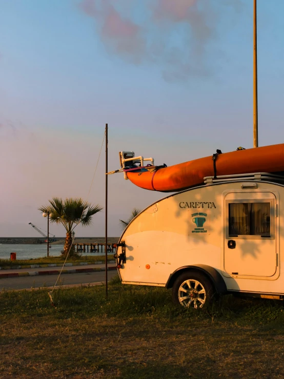 an orange raft sitting next to an rv