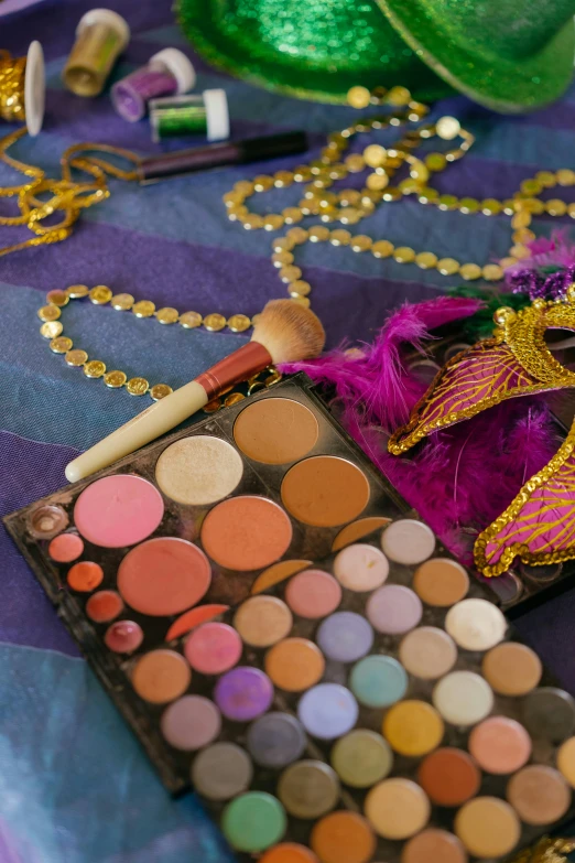 a table topped with makeup and a mirror