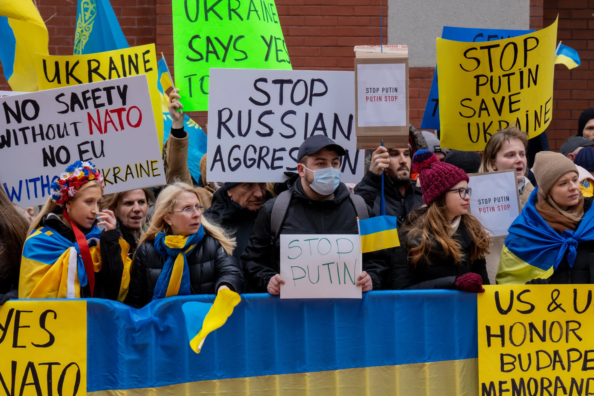 a group of protesters holding signs and holding a demonstration