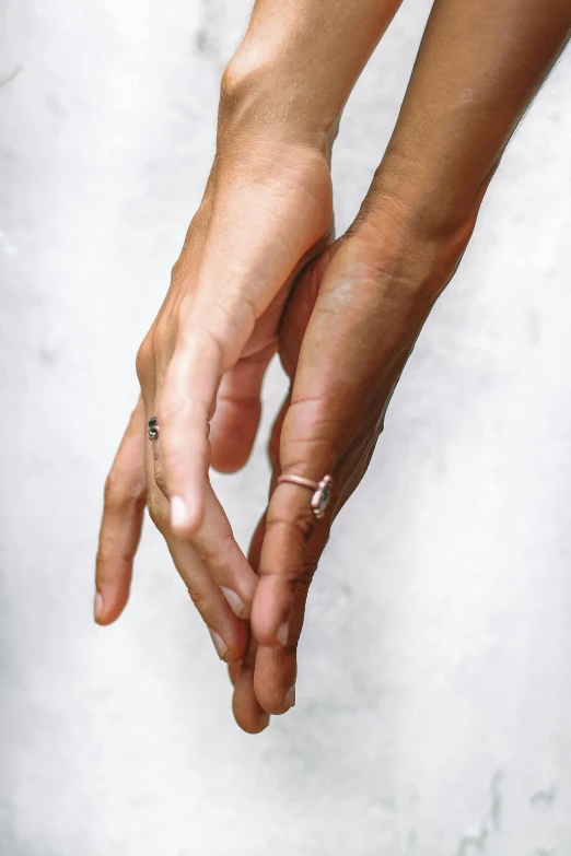 a couple holds hands with each other while standing in front of snow