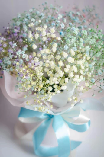 a bouquet of blue and white flowers sitting next to each other