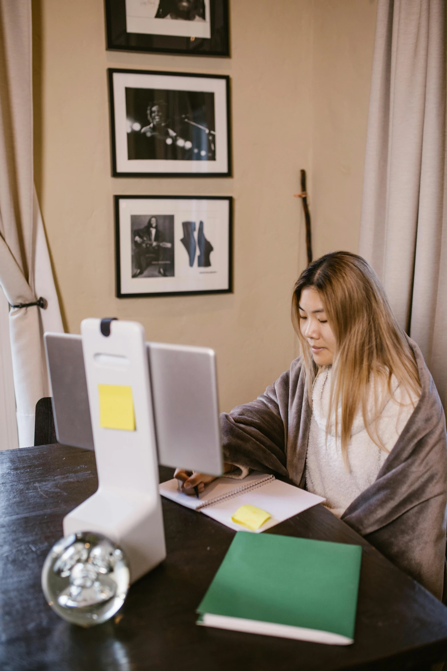 a woman sitting at a desk with her computer on