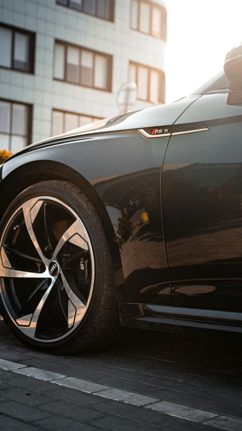 a black car is parked on the side of a street