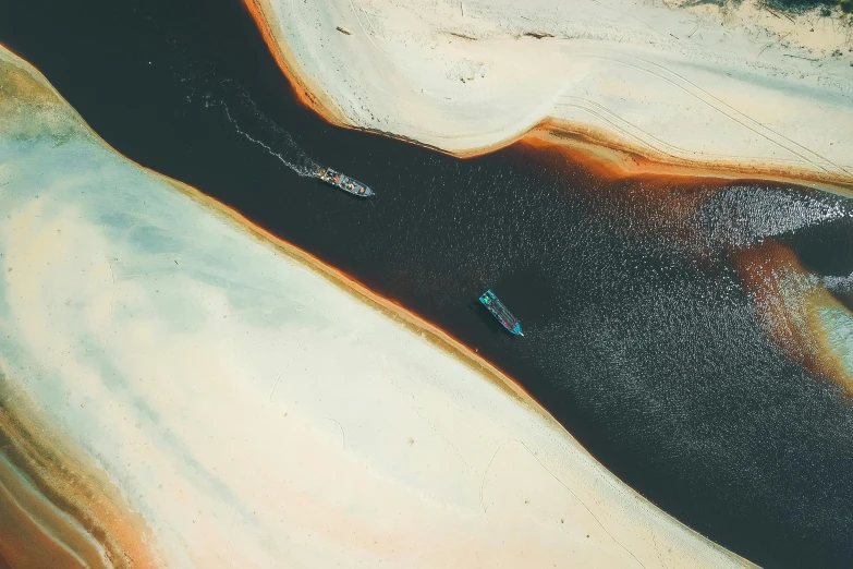 an aerial view of an ocean with a lot of sand