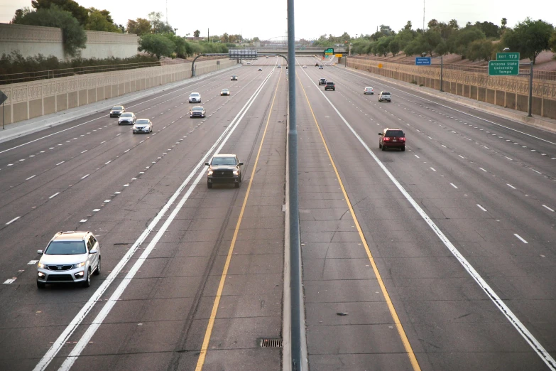 many cars and trucks driving along a highway