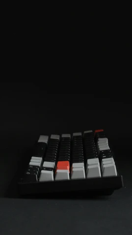 a multi colored key board sits against a black background