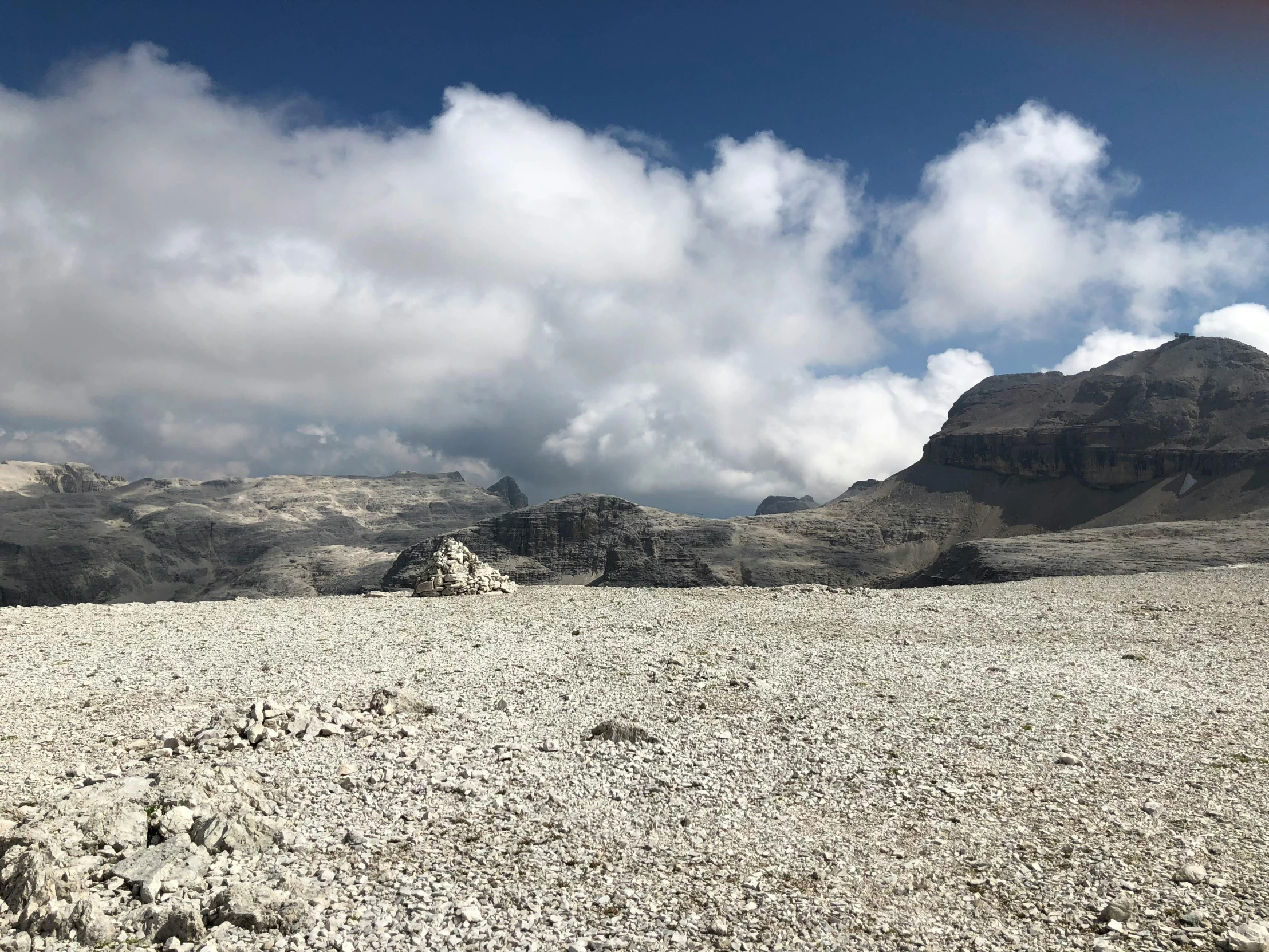 a dirt field covered in lots of rocks and boulders