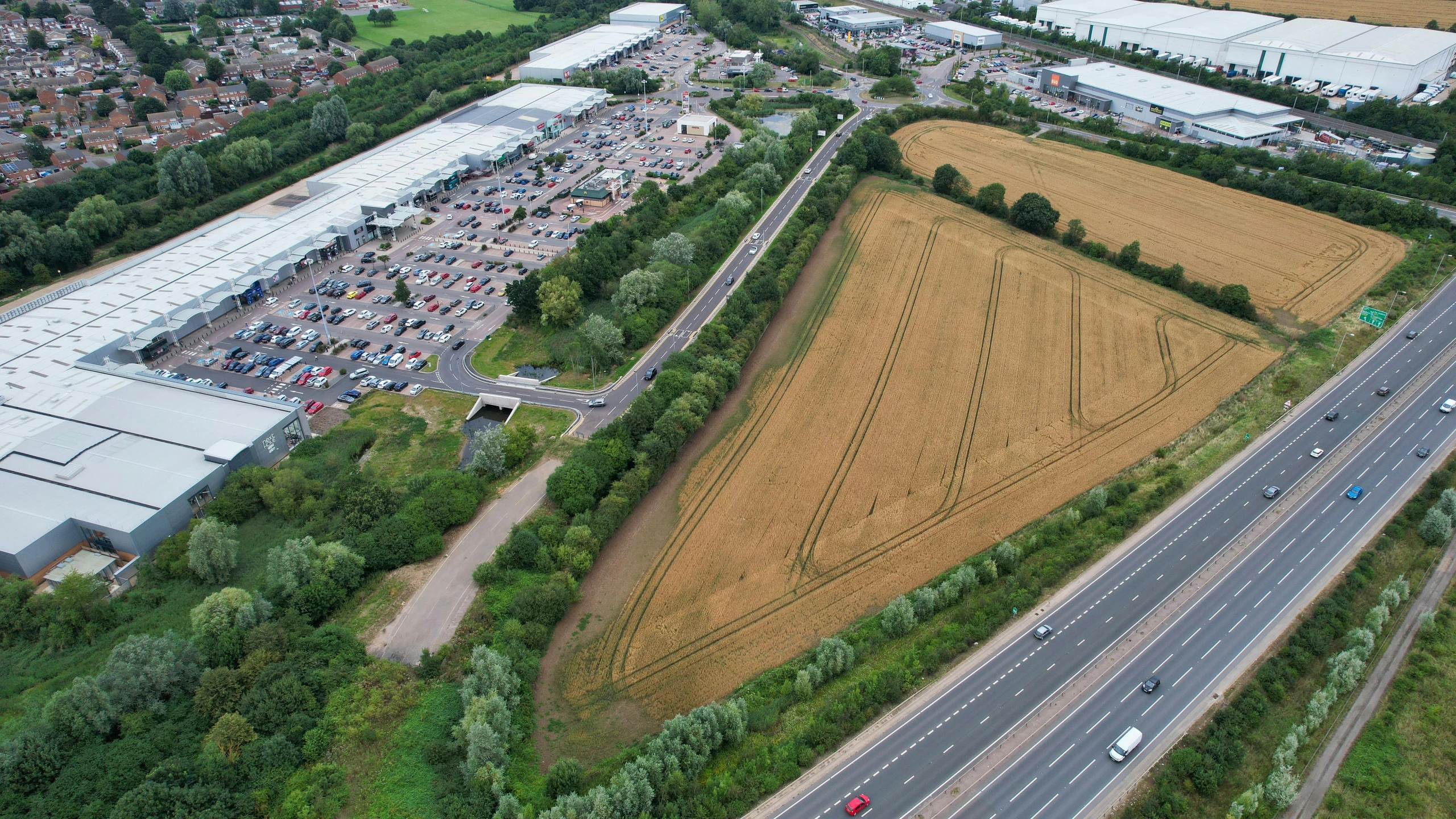 an aerial view of a town with fields and trees