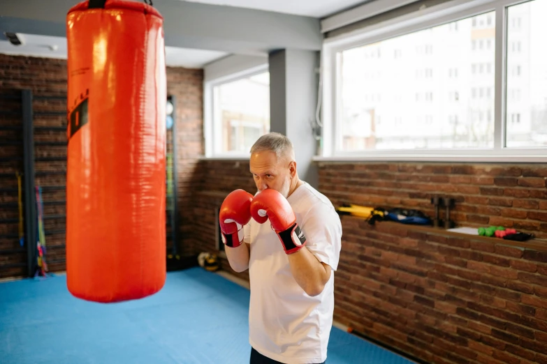 man with gloves boxing in the gym