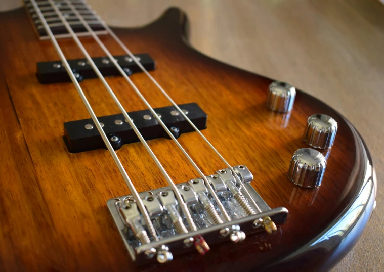 a brown guitar with an orange pickguard and a yellow tone