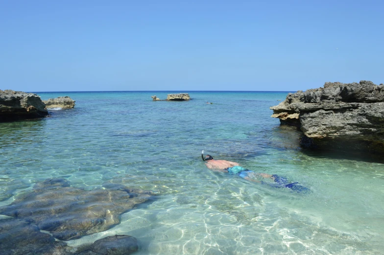 there are two men snorkling in the water