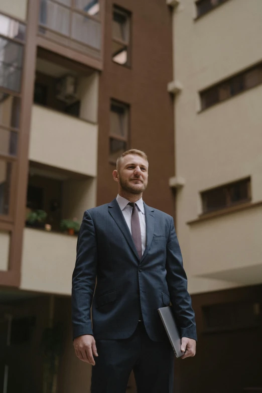 a man in a suit and tie posing for a picture