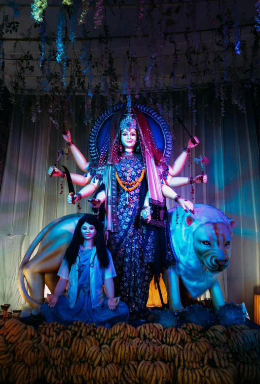 the indian woman is performing on stage next to two lions