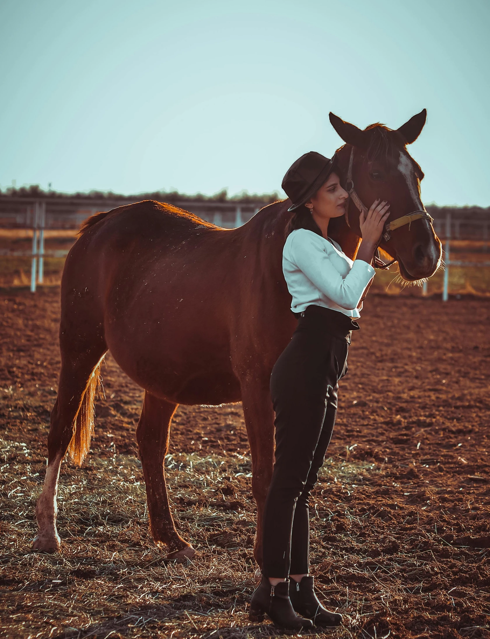 a woman standing in front of a horse with it's face next to her face