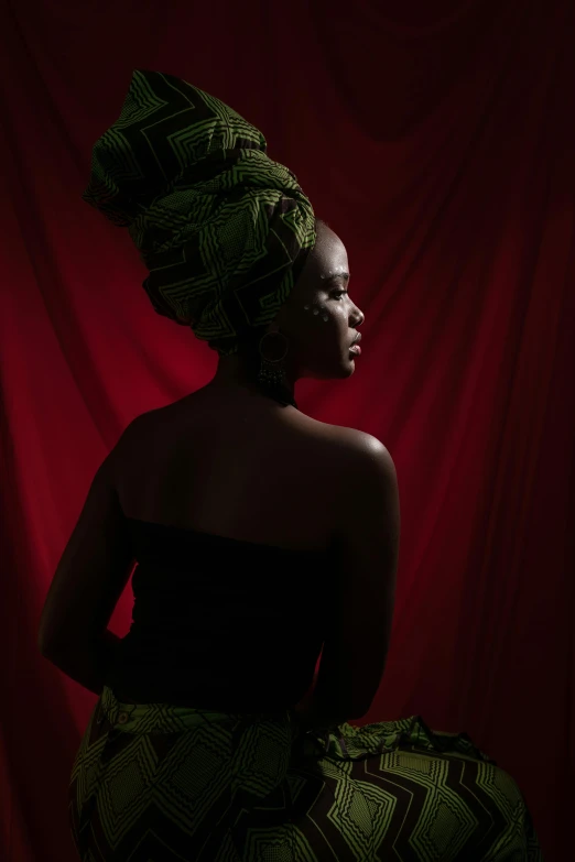 a black woman with an afro wearing a green dress