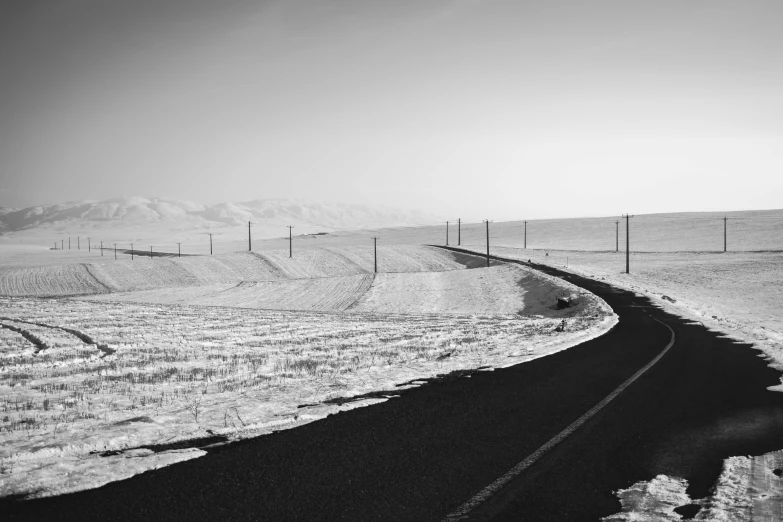 black and white pograph of a train track and mountains