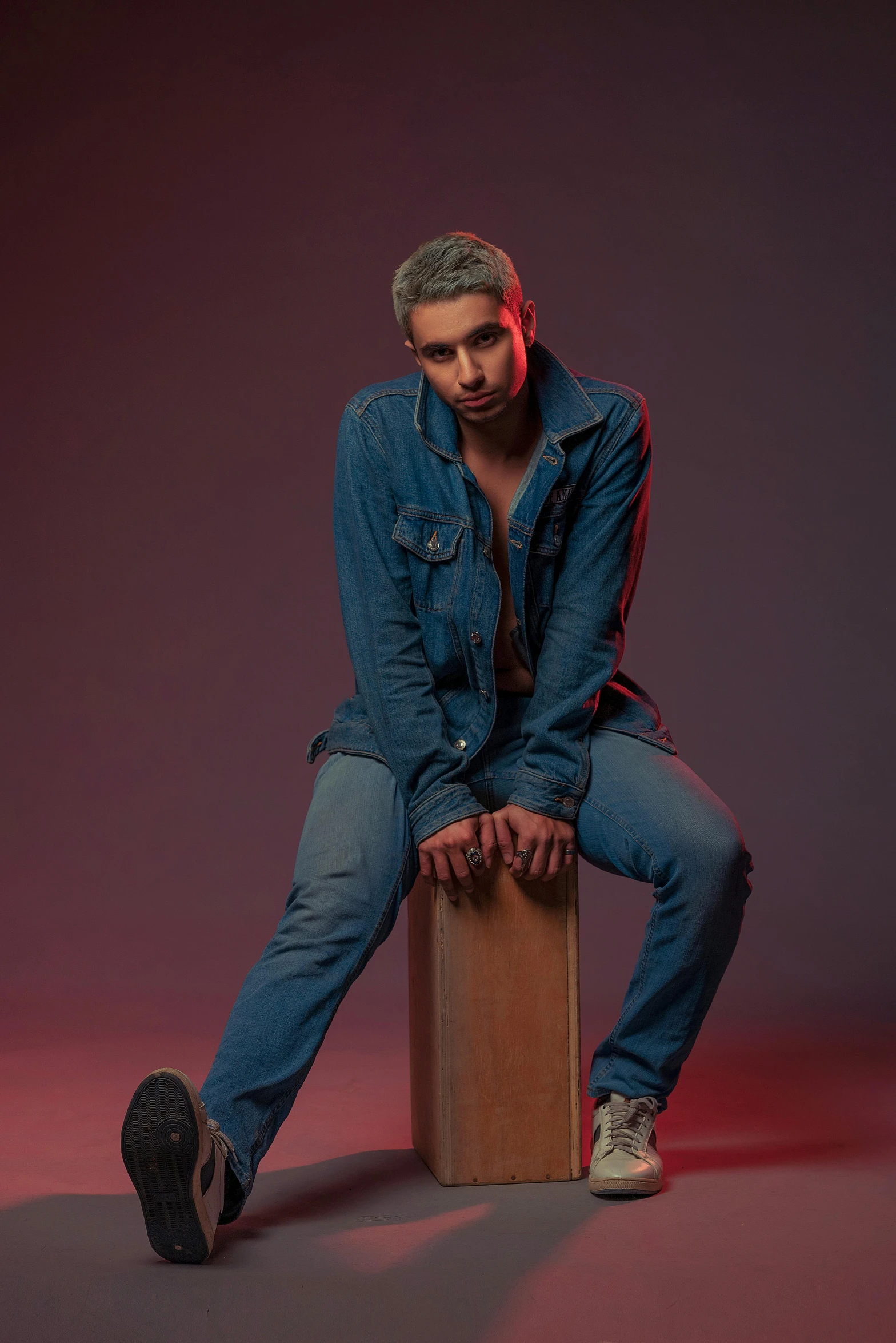 a man sitting on top of a wooden box