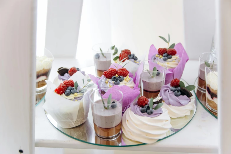 a dessert table with different cakes and fruits