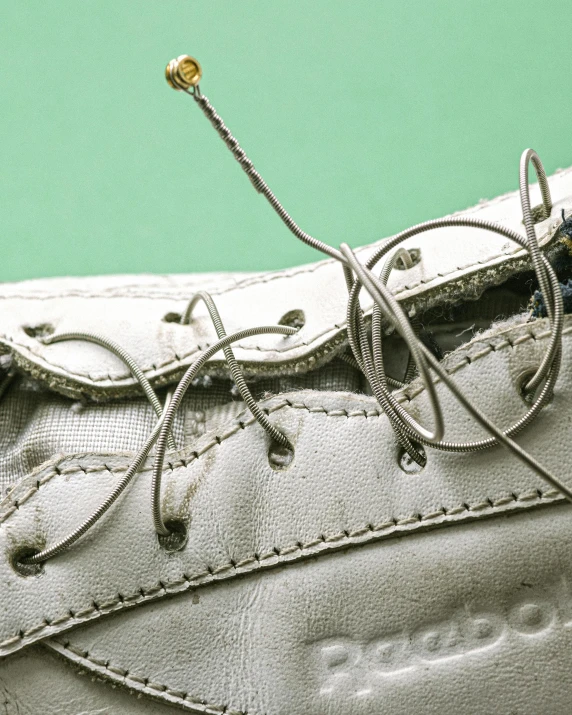 laces still attached to a pair of grey tennis shoes