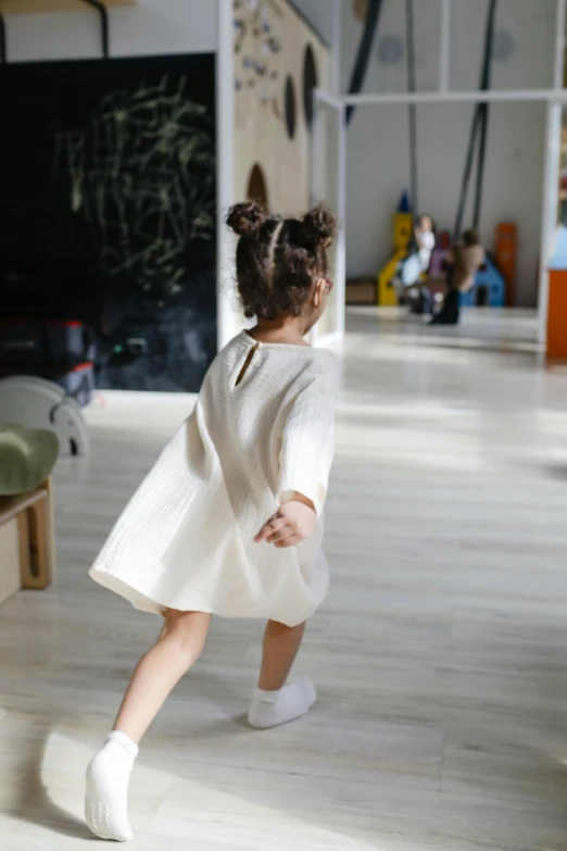 a child running on a hard wood floor