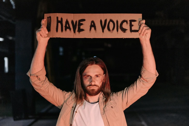 a man with a sign that says have a voice