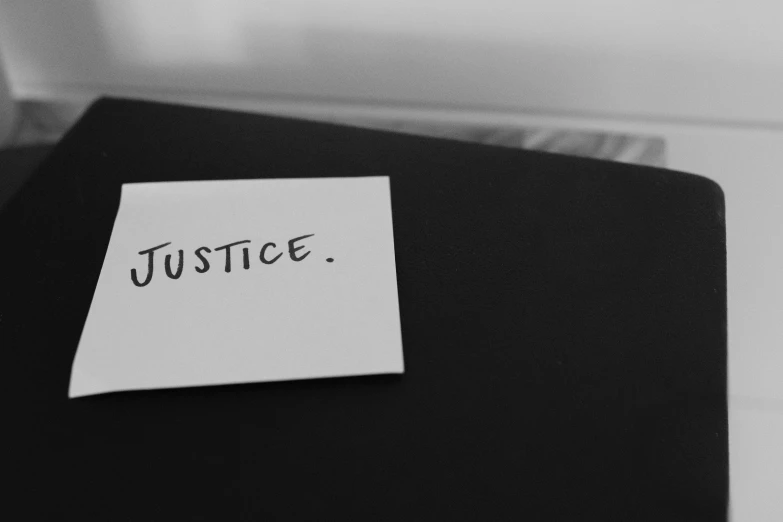 a piece of paper with the word justice on it