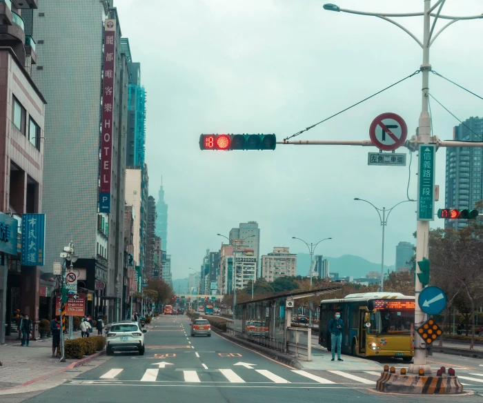 an intersection with the traffic light on and one vehicle turning